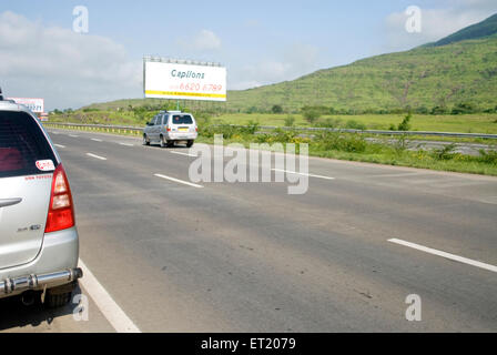 Two cars on Mumbai Pune express way ; Maharashtra ; India Stock Photo