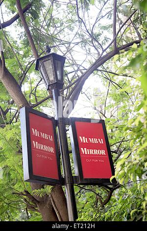 Mumbai Mirror Newspaper ; advertising on lamp poet ; Dr. Dadabhai Naoroji Road ; Bombay ; Mumbai ; Maharashtra ; India ; Asia ; Asian ; Indian Stock Photo
