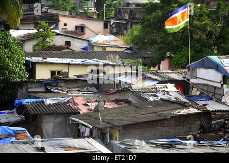 Maharashtra navnirman sena flag on hut in slum ; Mahim Sion Link Road ; Bombay Mumbai ; Maharashtra ; India 10 September 2009 Stock Photo