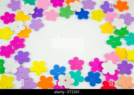 Colorful paper flowers arranged in a circle with copy space in the center Stock Photo