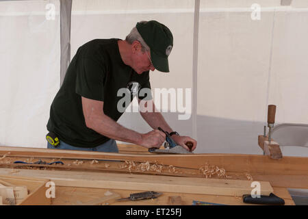 Man using a hand planer on wood - USA Stock Photo