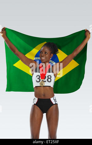 Female Athlete Holding a Brazilian Flag Stock Photo