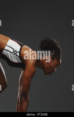 African Woman Runner Preparing To Start Stock Photo