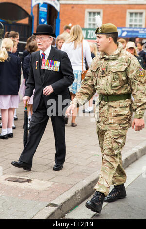 Cardiff, Wales, UK. 11th June, 2015. Roads were closed and crowds lined the streets in Cardiff city centre this morning as the Queen arrived to present new regimental colours to the Royal Welsh Regiment. The regiment, led by the Goat Major and the regimental mascot, Shenkin, marched from Cardiff Castle to the Millennium Stadium where the formal ceremony will take place. The Queen will then be the guest of the regiment for a celebratory dinner. Credit:  Chris Stevenson/Alamy Live News Stock Photo