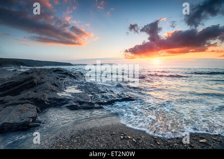 Dramatic sunset sky over the beach at Trevone Bay near Padstow in Cornwall Stock Photo