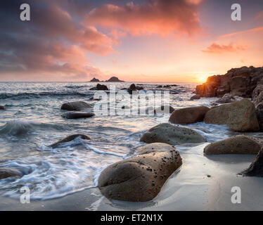 Sea rounded boulders at Porth Nanven beach in the far west of Cornwall Stock Photo