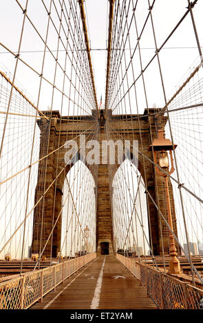 The Brooklyn Bridge spanning the East River from Manhattan to Brooklyn. The Bridge is a hybrid cable-stayed suspension bridge in New York City, USA Stock Photo