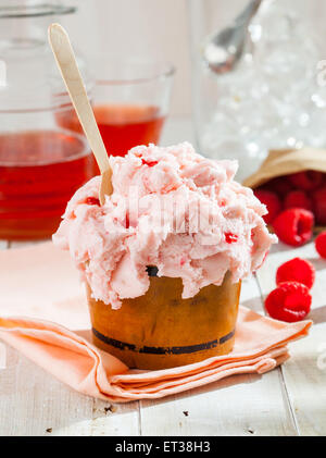 A home made raspberry ice cream on a sunny summer table. Stock Photo
