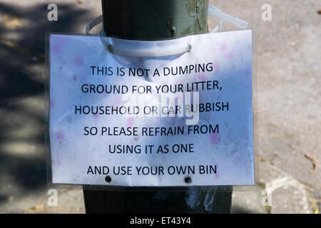 A homemade sign asking people to take their litter home and not dump it on the ground. Stock Photo
