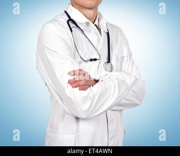 Young doctor with stethoscope on blue background Stock Photo