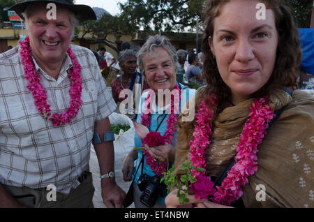 European tourists wear flower garlands at Thovalai flower market Stock Photo