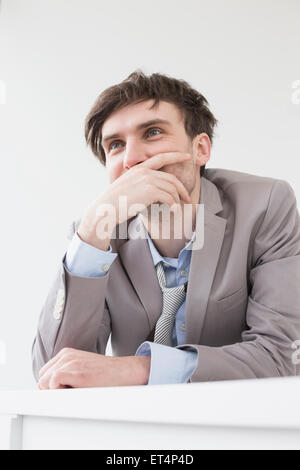 businessman leaning on desk in office, Leipzig, Saxony, Germany Stock Photo