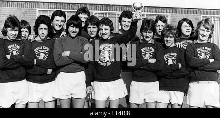 Benfield School skipper Steve Bruce holds up the Evening Chronicle Cup after his side had beaten Heaton 3-0 in today's final at Benfield Park. 11th March 1977.