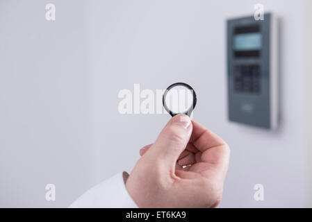 Man's hand opening door protected with security system, Munich, Bavaria, Germany Stock Photo