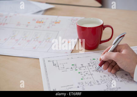 Engineer analysing wiring diagram, Munich, Bavaria, Germany Stock Photo