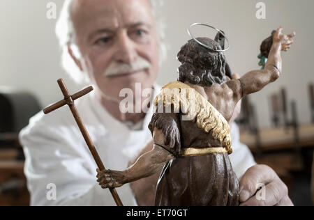 Senior sculptor works on a Jesus Christ statue at a workshop, Bavaria, Germany Stock Photo