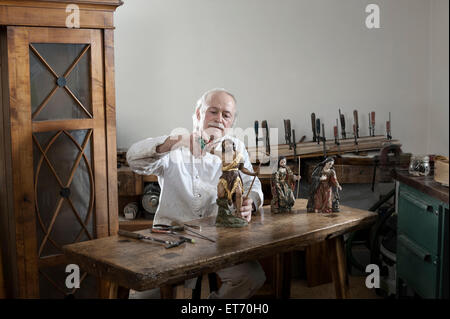 Senior sculptor works on a Jesus Christ statue at a workshop, Bavaria, Germany Stock Photo