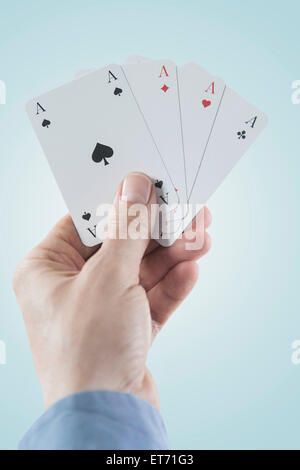 Close-up of man's hand holding four aces, Bavaria, Germany Stock Photo