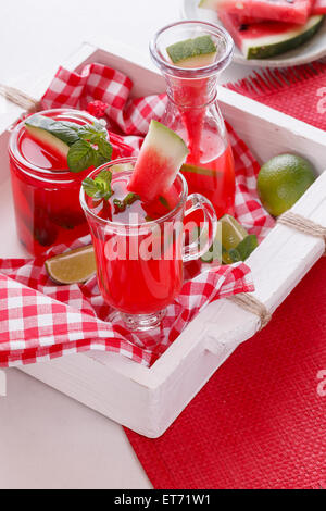 Watermelon cocktails. Freshly made watermelon cocktails and pieces of melon on a rustic wooden tray. Macro, selective focus Stock Photo