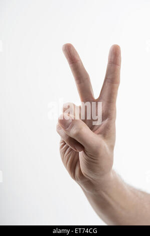 Male hand making peace sign, Bavaria, Germany Stock Photo