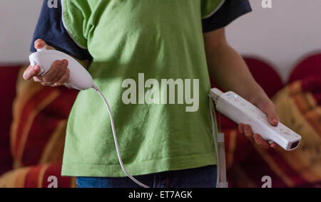 Boy at home holding Nintendo Wii computer game controller. Stock Photo