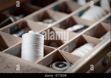 Reels of sewing threads in box Bavaria Germany Stock Photo