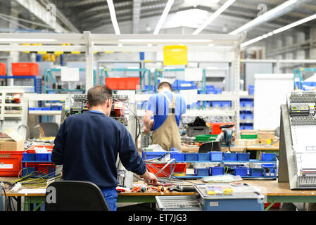 Workers in a switchboard construction factory Stock Photo