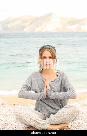 Teenage girl doing yoga on the beach, Baska, Croatia