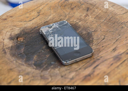 Close-up of smartphone with cracked screen on burnt table Bavaria Germany Stock Photo