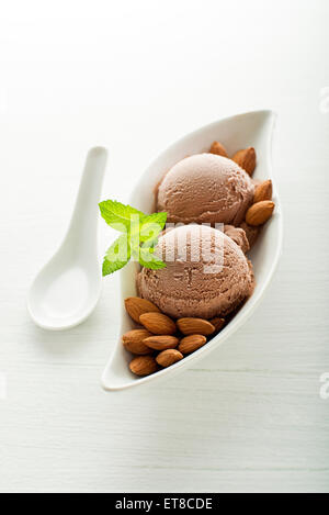 Fresh almond ice cream on white plate close up Stock Photo