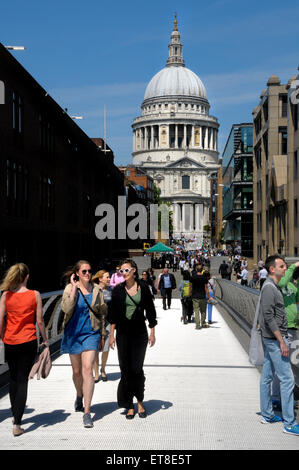 London, England, UK. People crossing the Millennium Bridge between St Paul's Cathedral and Tate Modern Stock Photo