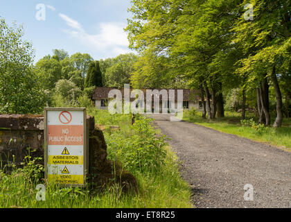 Asbestos warning sign outside the abandoned Killearn hospital that was commisioned in 1938 in preparation for the world war II Stock Photo