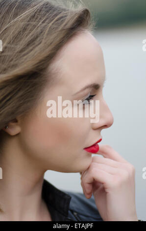 Thoughtful young woman looking away outdoors Stock Photo
