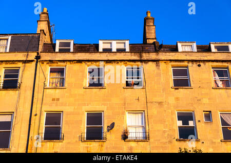 Man looks out of apartment window at sunrise in Bath Somerset England UK Stock Photo