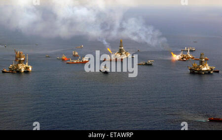 The Discoverer Enterprise and the Q4000 continue to flare off gasses as vessels gather around the ruptured riser at the BP Deepwater Horizon oil spill disaster site as efforts to contain the gusher continue June 28, 2010 in the Gulf of Mexico. Stock Photo