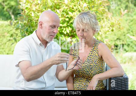 a middle-aged couple with eyeglasses outside Stock Photo