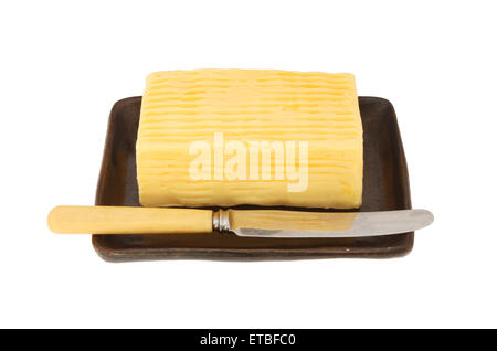 Block of butter and butter knife on a dish isolated against white Stock Photo