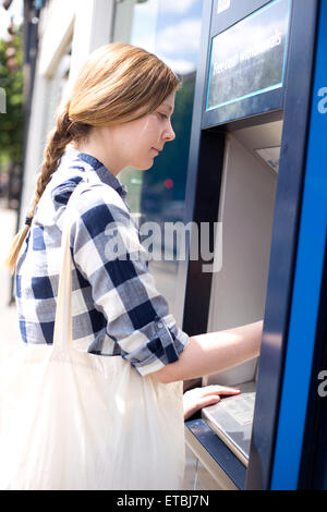 young woman at the atm machine. Stock Photo