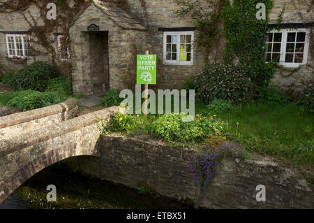 Vote green party. A political placard in a rural cottage garden supports the Green Party in the 2015 UK general election. Dorset, England, UK. Stock Photo