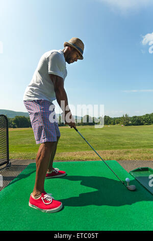 Golfer Teeing Up at the Driving Range Stock Photo