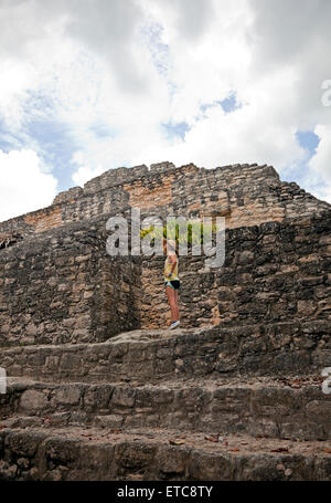 A young girl climbs a pyramid at Chacchoben on the Mexican Riviera, settled by the Maya as early as 200 BC. Stock Photo