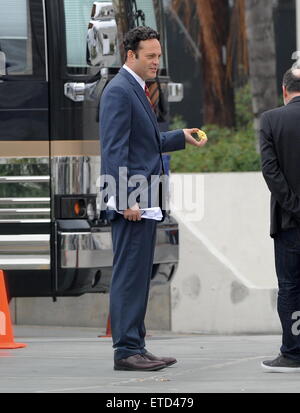 Actor Vince Vaughn wearing a blue suit while eating an apple on the set of 'Unfinished Business' filming in Los Angeles Ca.  Featuring: Vince Vaughn Where: Los Angeles, California, United States When: 20 Jan 2015 Credit: Cousart/JFXimages/WENN.com Stock Photo