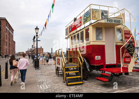 Ancient restored, open top bus empty Omnibus vehicle, which is used as a novelty sweet stall,  on the Dockside, Liverpool, Merseyside, UK Stock Photo