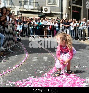 (150613) -- LISBON, June 13, 2015 (Xinhua) -- A little girl collects colored ribbons during a group wedding in Lisbon, Portugal, on June 12, 2015. A total of 11 couples married during a group wedding at Lisbon city cathedral Friday. (Xinhua/Zhang Liyun) (zhf) Stock Photo