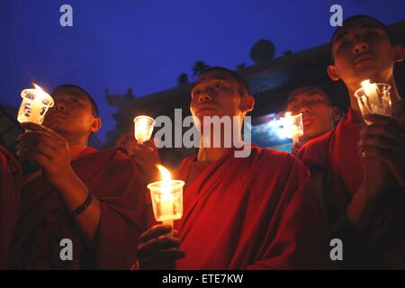 Kathmandu, Nepal. 12th June, 2015. Nepalese Buddhist monks participate in a candle light vigil and offer prayers to memorize earthquake victims at Bouddhanath Stupa in Kathmandu, Nepal, on June 12, 2015. © Pratap Thapa/Xinhua/Alamy Live News Stock Photo