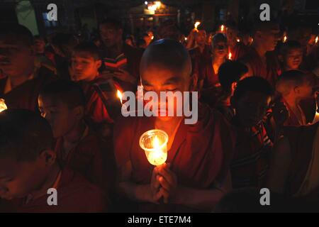 Kathmandu, Nepal. 12th June, 2015. Nepalese Buddhist monks participate in a candle light vigil and offer prayers to memorize earthquake victims at Bouddhanath Stupa in Kathmandu, Nepal, on June 12, 2015. © Pratap Thapa/Xinhua/Alamy Live News Stock Photo