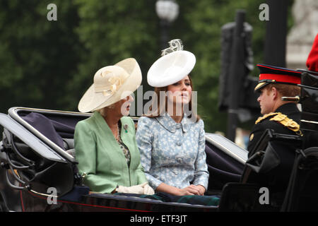 London, UK. 13th June, 2015. Camilla, Duchess of Cornwall with Catherine, Duchess of Cambridge and Prince Harry seen on a horse drawn carriage at the Mall.  .Since 1987, The Queen has attended in a carriage rather than riding, which she did before that on 36 occasions, riding side-saddle and wearing the uniform of the regiment whose Colour was being trooped. Credit:  david mbiyu/Alamy Live News Stock Photo