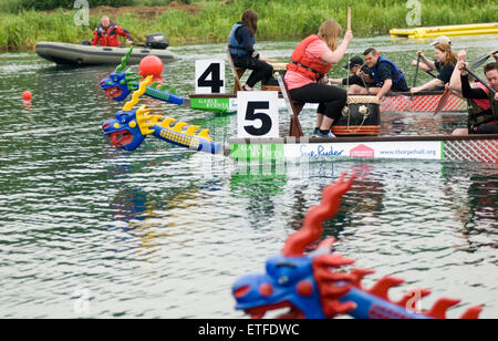 Peterborough England June 13th 2015: Wet weather does not stop play at the 17th  annual Charity Dragon Boat Festival in aid of Sue Ryder Thorpe Hall Hospice, visitors braved the rain to watch the action including one of the dragon boat's sinking. Credit: Clifford Norton/Alamy Live News Stock Photo