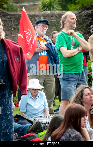 Exeter, Devon, UK. 13th June, 2015. Rally member listens to the speeches at the Devon 'End Austerity NOW!' Rally organised in Northernhay Gardens, Exeter on June13th, 2015 in Exeter, UK Credit:  Clive Chilvers/Alamy Live News Stock Photo