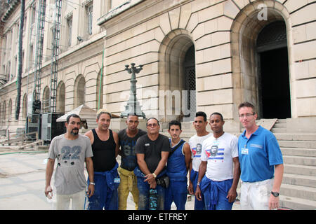 Michael Diegmann (R) poses with several of his Cuban employees in Havana, Cuba, 03 June 2015. Diegmann is one of 400 people involved in the remodeling of El Capitolio, former parliamentary building and one of Havana's landmarks. The German entrepreneur has been operating with his company MD Projektmanagement in Cuba for almost two years. Photo: Isaac Risco/dpa Stock Photo